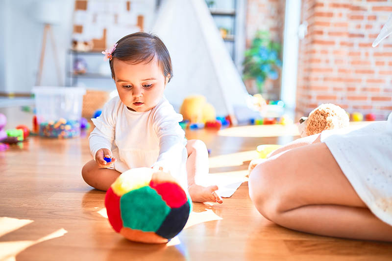 Infant playing with toys