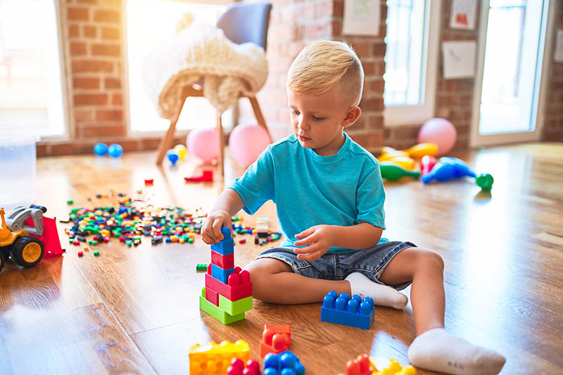 Young child playing with toy blocks